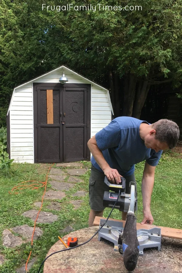From ugly to farmhouse shed makeover on a budget! The projects at our mobile home makeover continue - this time we redo our ugly old shed by giving it new paint and a natural wood shed door idea. A pretty cheap DIY shed transformation! #howto #diy #shed #outdoorproject #makeover #farmhouse #cottage #cabin FarmhouseShedMakeoverAddingBoardstodoors