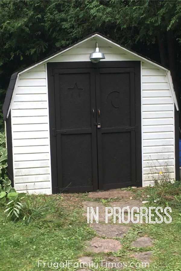 From ugly to farmhouse shed makeover on a budget! The projects at our mobile home makeover continue - this time we redo our ugly old shed by giving it new paint and a natural wood shed door idea. A pretty cheap DIY shed transformation! #howto #diy #shed #outdoorproject #makeover #farmhouse #cottage #cabin budget shed makeover