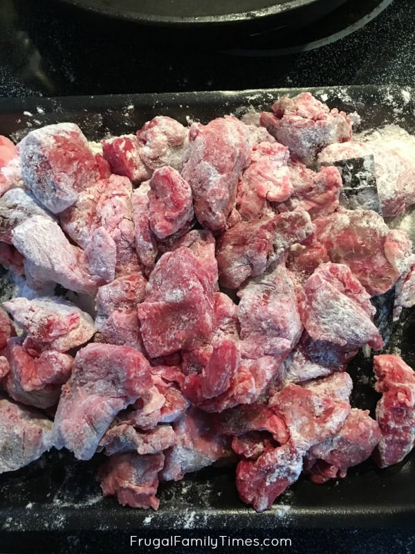 flour the beef for Slow Cooker Beef Stew with Red Wine