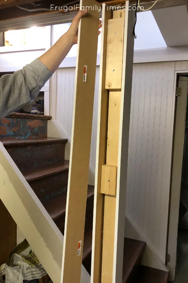 Hidden Storage Under Stairs (with Modern DIY Basement Railing) 5 basement railing pillar covering post