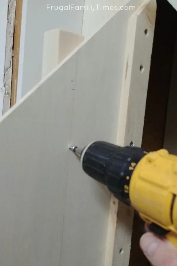 Hidden Storage Under Stairs (with Modern DIY Basement Railing) 14 screw false ballusters to back of door