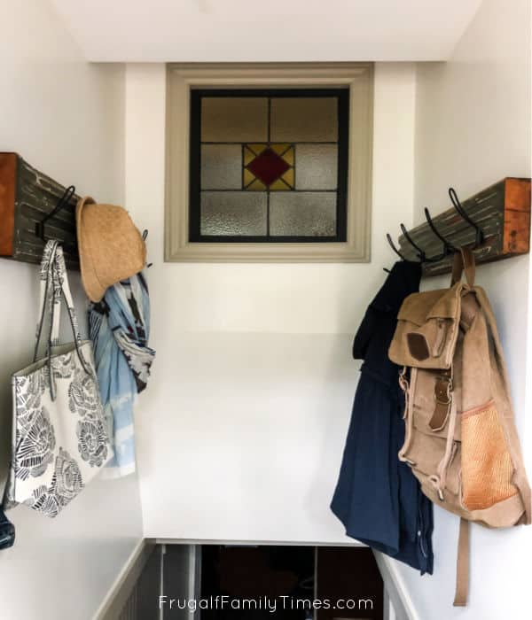 stairwell with hooks for storage and reclaimed wood