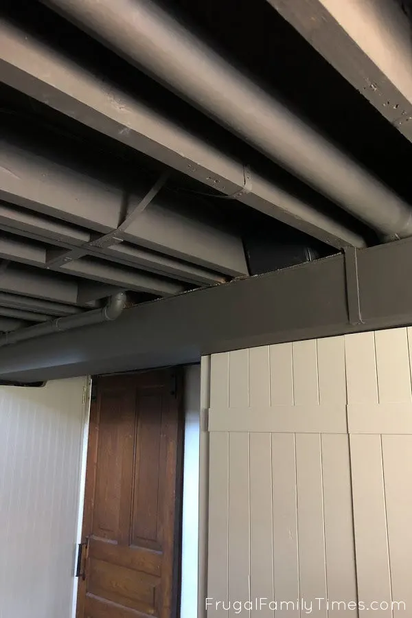 Our Painted Basement Ceiling: WITHOUT a Sprayer and the Perfect Black Paint 3 black painted basement ceiling