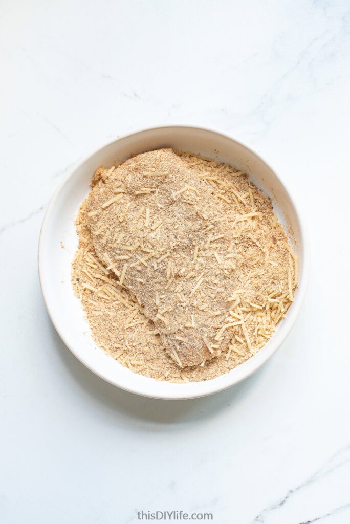 evenly coat chicken in garlic parmesan cheese egg mixture