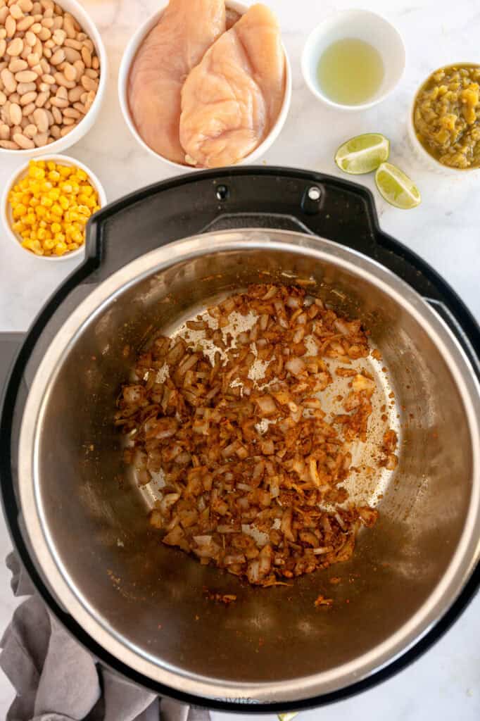 onions and spices in cream cheese chicken chili instant pot