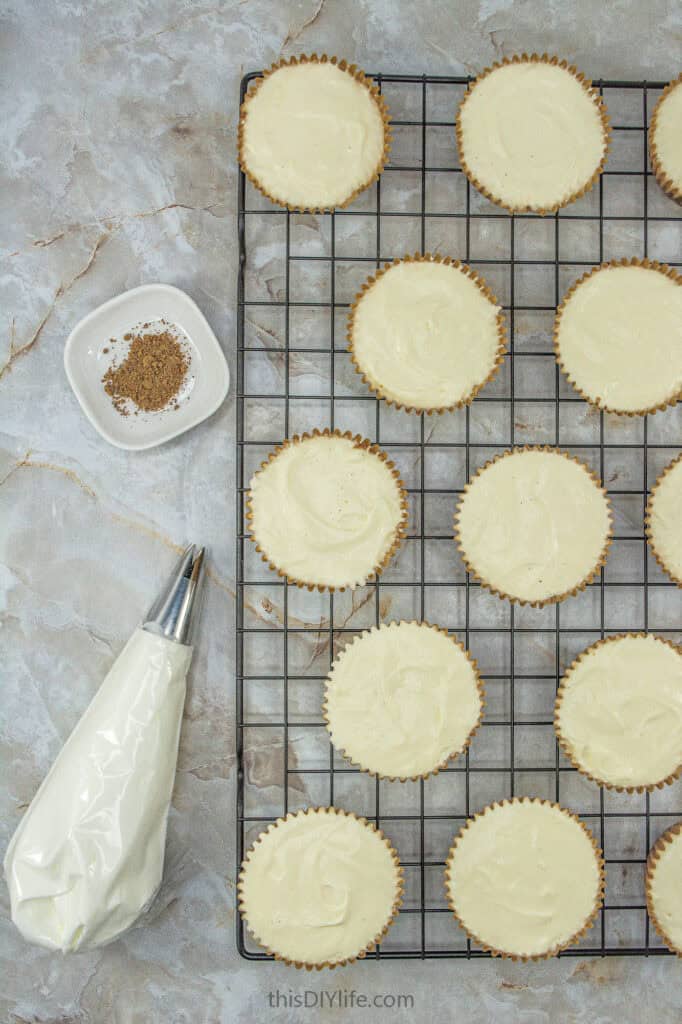 adding topping to Easy No Bake Eggnog Cheesecake