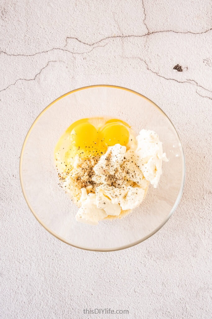 In a medium-sized bowl, beat the eggs, add the ricotta and Parmesan, salt and pepper
