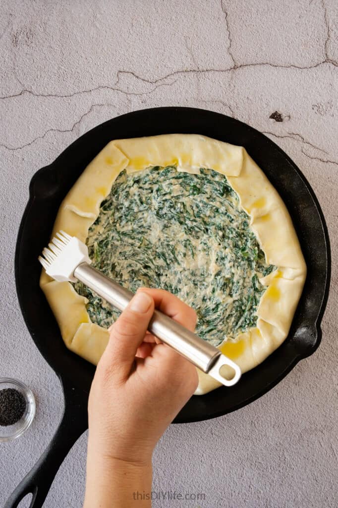 Melt the remaining (1/2 Tbsp) butter and brush the edges of the quiche.