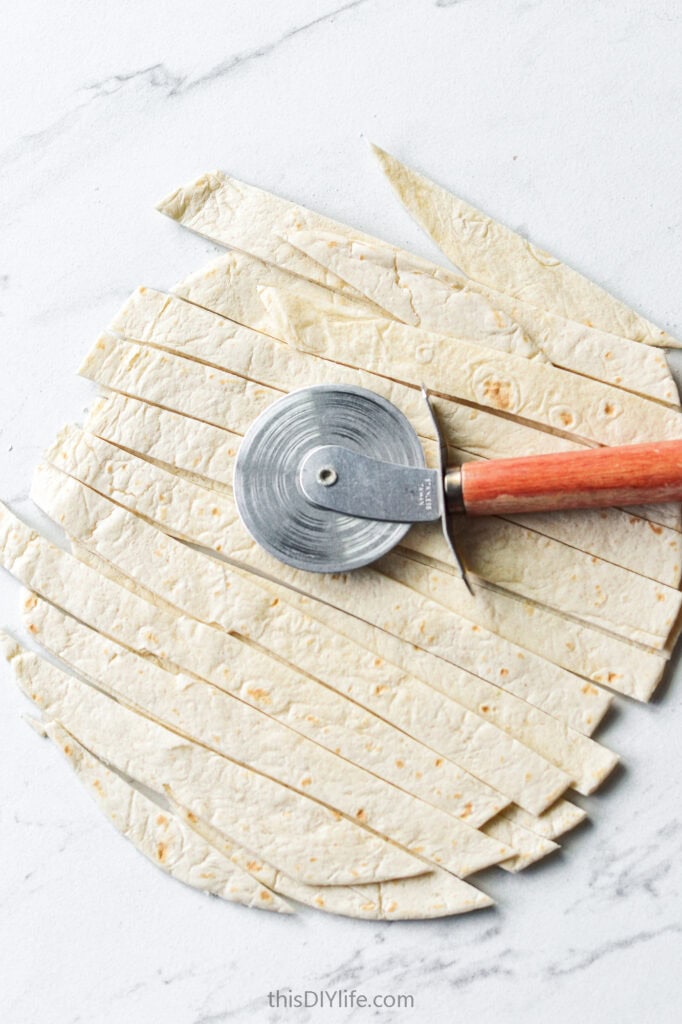cut up tortillas for mummy dip