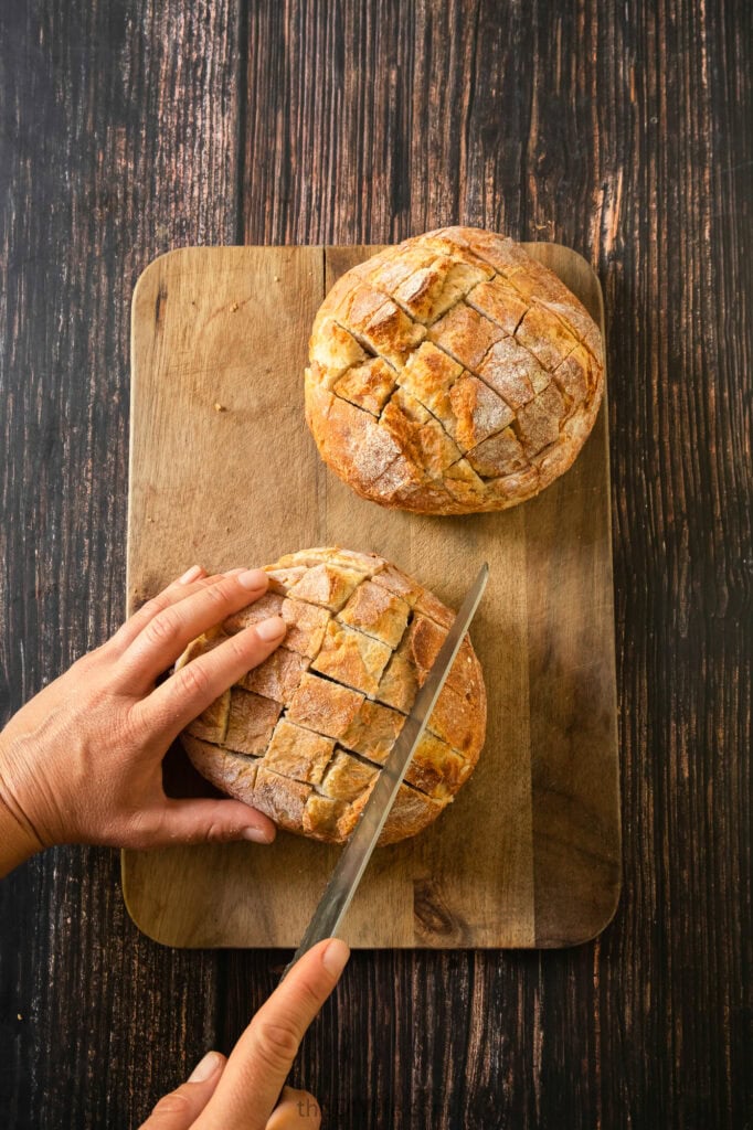 slicing the bread for cheesy pullapart garlic bread