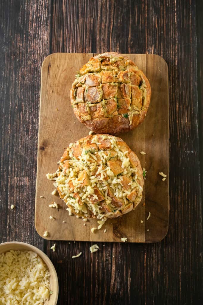 Adding the Cheese for the cheesy pull-apart garlic bread