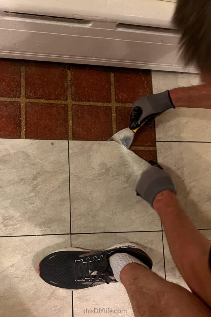 peeling up old tiles