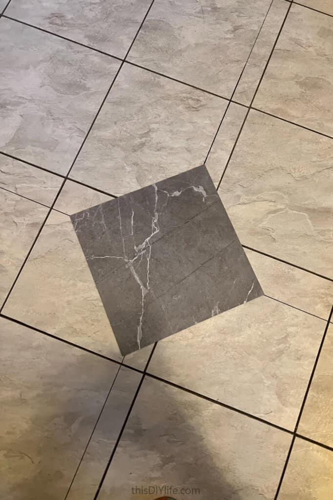 laying first tile for diy checkerboard floor