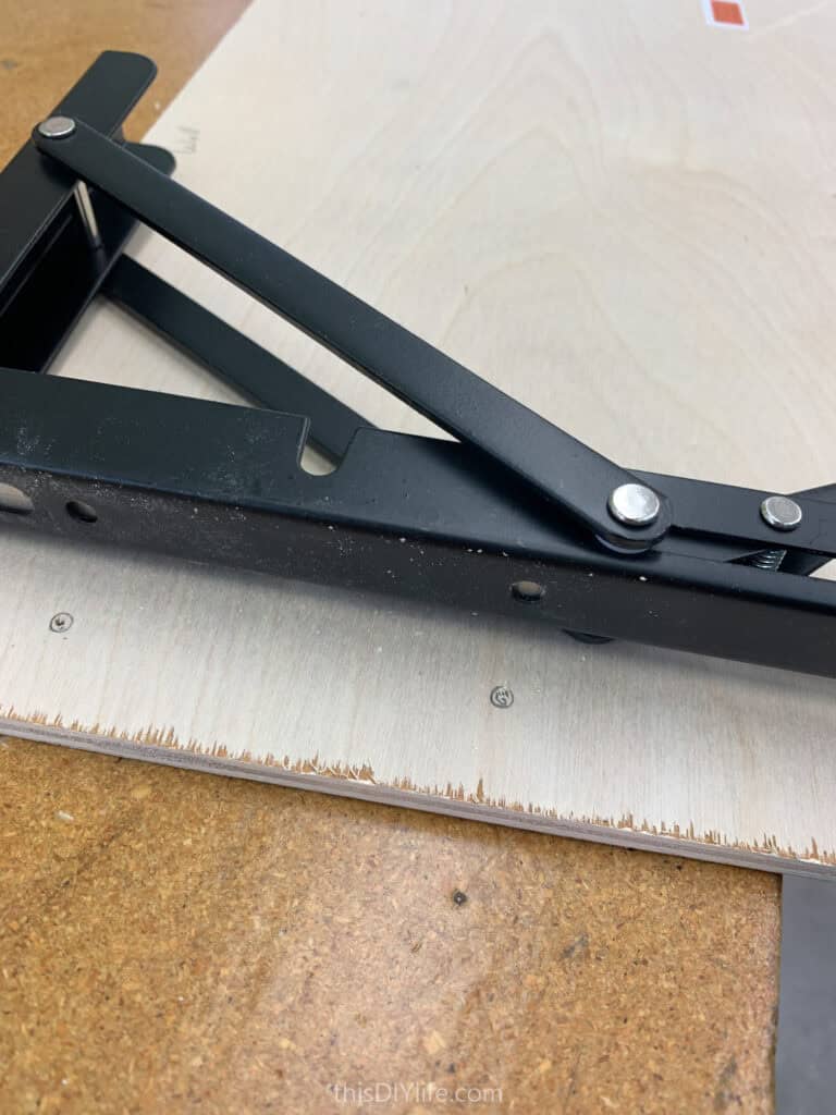 attaching folding brackets to shelf