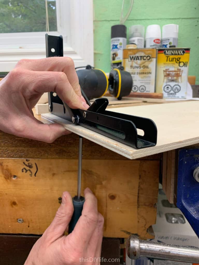 attaching folding brackets to projector shelf