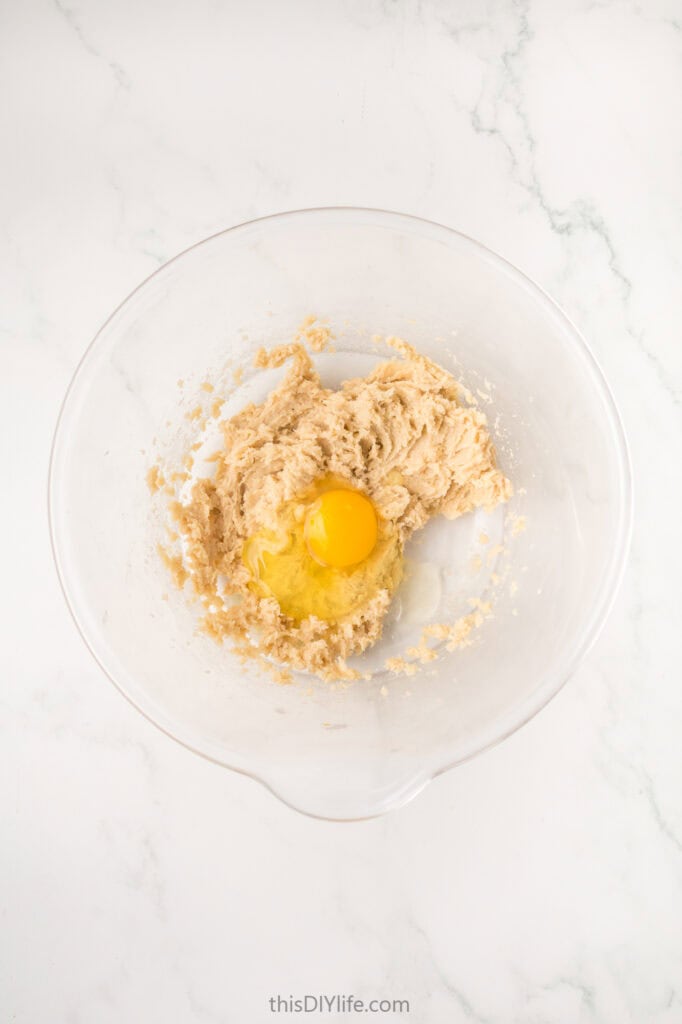 adding an egg to butter and sugar mixture